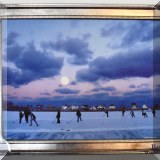 A05. Limited edition signed serigraph on canvas of a moonlit hockey game. Canvas: 18”h x 24”w